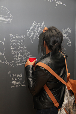 woman writing on chalkboard