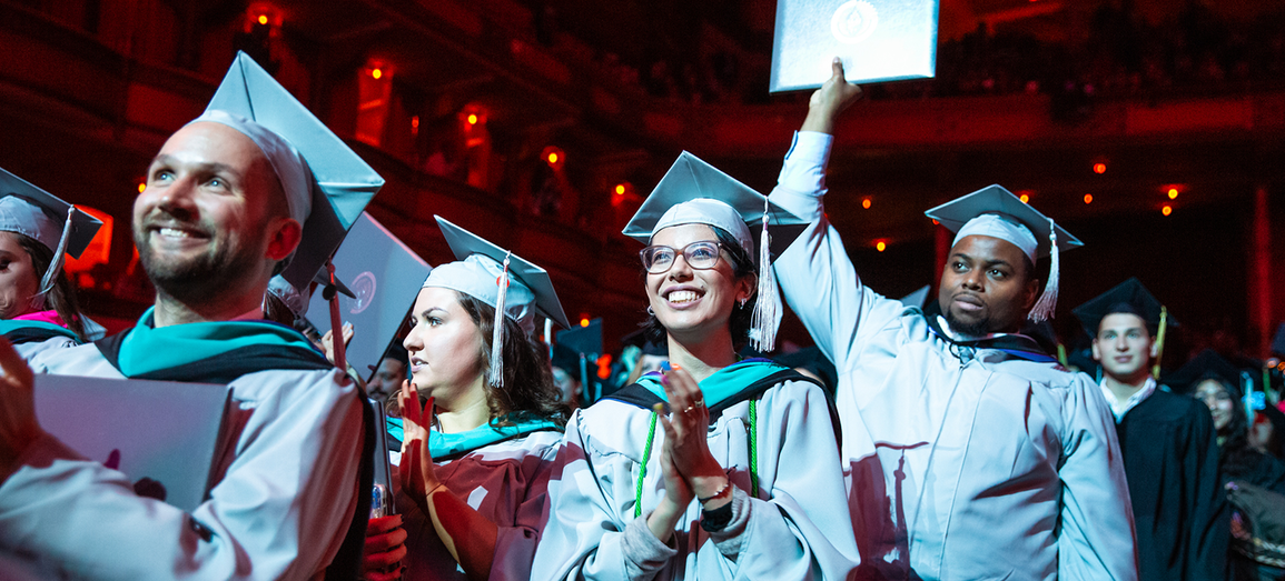 Students celebrate graduation in their caps and gowns