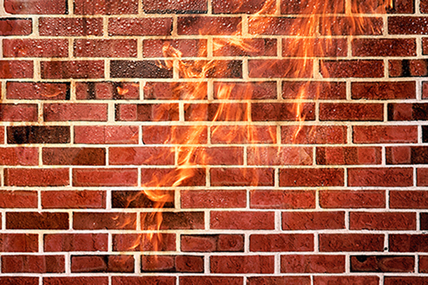 Flames in front of brick wall