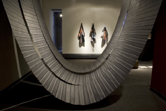 art installation comprised of 3 large hanging curved sheets of paper