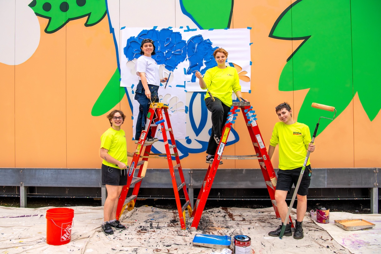 Students working on the "Curious Bunny" mural on the Student Center.