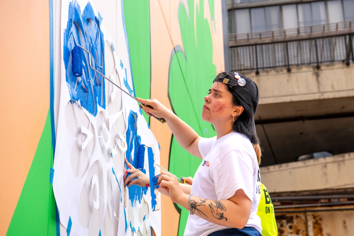 Students working on the "Curious Bunny" mural on the Student Center.