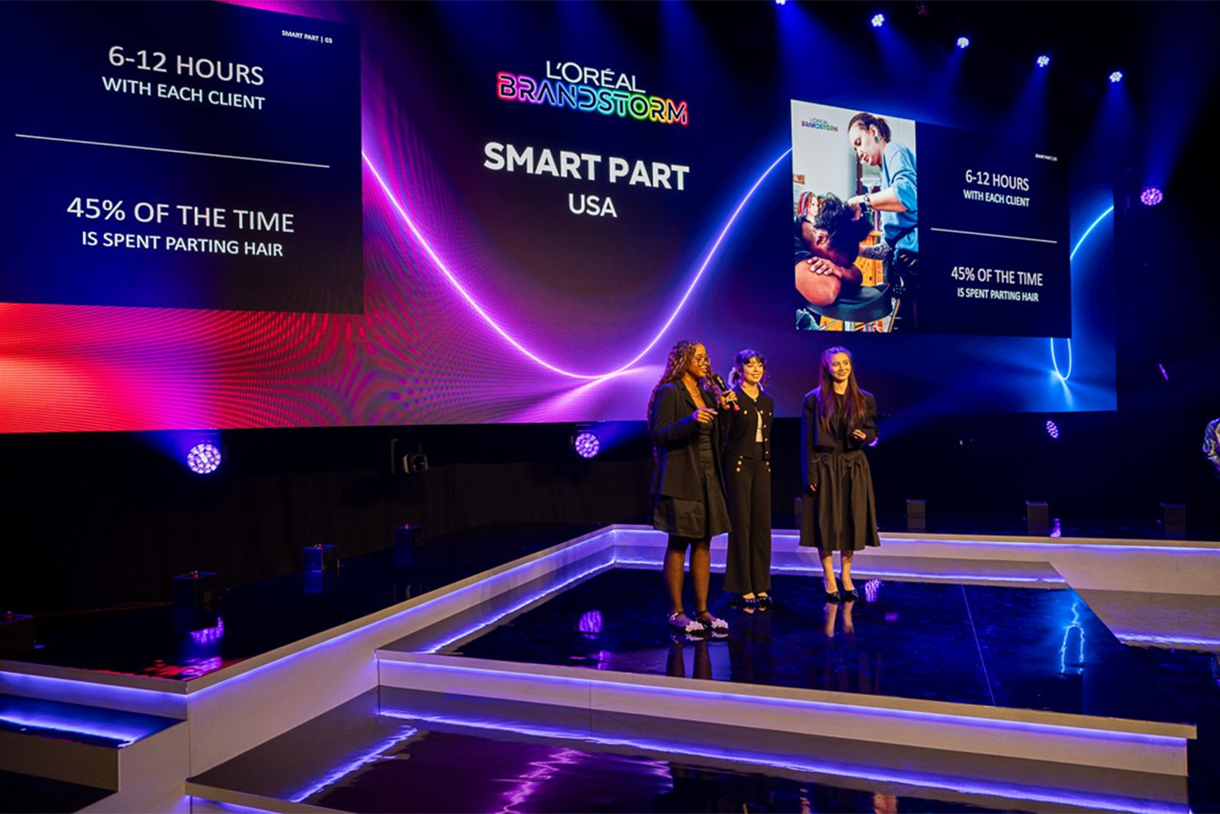 three students on stage at competition