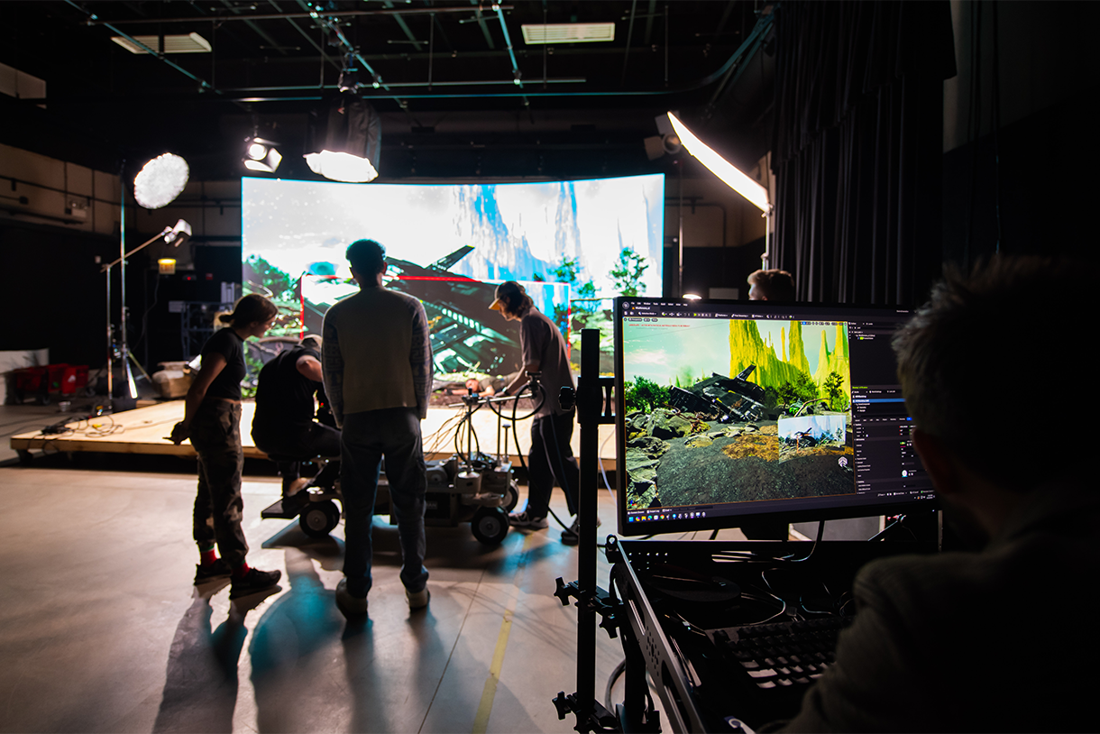 students filming on set with virtual production with LED screen in background