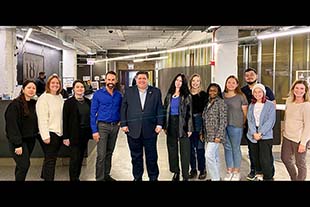 A group of Columbia students pose with Governor J.B. Pritzker