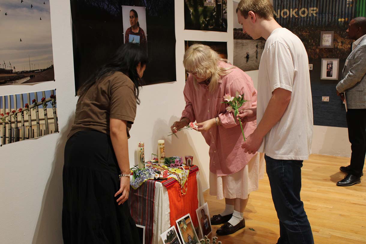 Students putting flowers on the ofrenda